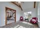 Inviting living room features exposed beams, a vintage rug, and ample natural light from large windows at 271 Trestle Rd, Locust Grove, GA 30248