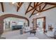 Elegant living room featuring exposed beams, a brick archway and seamless flow to the kitchen at 271 Trestle Rd, Locust Grove, GA 30248