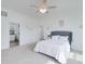 Bright bedroom boasts neutral walls, carpet, and a large gray upholstered headboard bed at 271 Trestle Rd, Locust Grove, GA 30248