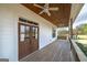 Inviting outdoor porch area featuring wood floors, ceiling fans, and a swing at 271 Trestle Rd, Locust Grove, GA 30248