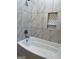 Bathroom with a soaking tub and tiled walls at 2577 Headland Dr, East Point, GA 30344