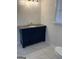Bathroom with a navy vanity, granite countertop and white tile floor at 2577 Headland Dr, East Point, GA 30344