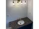 Bathroom vanity with granite countertop and modern lighting at 2577 Headland Dr, East Point, GA 30344