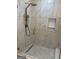 Modern shower with stone floors, marble tile surround and gold hardware at 2577 Headland Dr, East Point, GA 30344