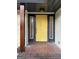 Charming yellow front door with sidelights and brick accents, creating an inviting entrance at 2577 Headland Dr, East Point, GA 30344
