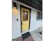 Quaint yellow front door has decorative glass and a brick stoop at 2577 Headland Dr, East Point, GA 30344