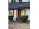 Close up view of a bright yellow front door and white painted brick exterior at 2577 Headland Dr, East Point, GA 30344