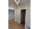 Hallway with hardwood floors leading to multiple rooms with decorative chandelier at 2577 Headland Dr, East Point, GA 30344