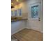 Kitchen boasts stone countertops, a door with decorative glass, and bright light from shuttered windows at 2577 Headland Dr, East Point, GA 30344