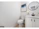 Charming half bath with a modern round mirror and stylish vanity at 2391 Wellborn Hills Ct, Lithonia, GA 30058