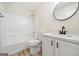 Modern bathroom with a shower-tub combo, white vanity, and sleek fixtures at 2391 Wellborn Hills Ct, Lithonia, GA 30058