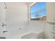 Clean bathroom with white tile and a large window providing natural light at 2391 Wellborn Hills Ct, Lithonia, GA 30058