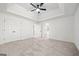 Large bedroom with a tray ceiling, carpet, closet and natural light at 2391 Wellborn Hills Ct, Lithonia, GA 30058