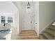 Bright entryway featuring wood floors, a modern light fixture, and access to the living room and staircase at 2391 Wellborn Hills Ct, Lithonia, GA 30058