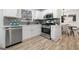 Bright kitchen featuring white cabinets, stainless steel appliances, and open access to the dining area at 2391 Wellborn Hills Ct, Lithonia, GA 30058