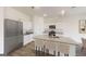 Modern kitchen with an island with seating, granite countertops, stainless steel appliances, and white cabinets at 106 Silverton Dr, Dacula, GA 30019