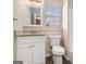 Fresh bathroom showcases a granite-topped vanity, toilet, and a large mirror for added convenience at 3822 Holland Dr, Snellville, GA 30039