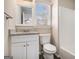 Updated bathroom features a granite vanity, framed mirror, and a toilet, complemented by natural light at 3822 Holland Dr, Snellville, GA 30039