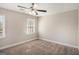 Neutral bedroom with carpet floors, a window for natural light, and a ceiling fan at 3822 Holland Dr, Snellville, GA 30039
