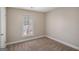 Neutral bedroom boasts plush carpeting and a window that allows an abundance of natural light at 3822 Holland Dr, Snellville, GA 30039