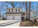 Charming two-story home with a two-car garage, brick accents, covered porch, and mature trees at 3822 Holland Dr, Snellville, GA 30039