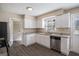 Modern kitchen with granite countertops, stainless steel appliances, white cabinets, and hardwood floors at 3822 Holland Dr, Snellville, GA 30039