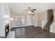 Bright living room featuring a fireplace, hardwood floors, and a staircase leading to the upper level at 3822 Holland Dr, Snellville, GA 30039