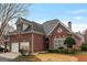 Lovely brick home featuring a well-manicured lawn and attached two-car garage at 6275 Glen Oaks Ln, Atlanta, GA 30328