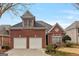 Charming brick home with a two-car garage and well-maintained front yard at 6275 Glen Oaks Ln, Atlanta, GA 30328