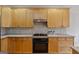 Close up on the Kitchen: Wood cabinets and stainless steel appliances, including gas range at 6275 Glen Oaks Ln, Atlanta, GA 30328