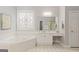 Main bathroom: Relaxing soaking tub, dual vanities, and decorative window create a spa-like experience at 6275 Glen Oaks Ln, Atlanta, GA 30328