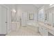 Bright main bathroom with double sinks, a soaking tub, and a decorative window at 6275 Glen Oaks Ln, Atlanta, GA 30328