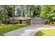 Charming single Gathering home featuring a stone and siding exterior, two-car garage, and mature landscaping at 1408 Fairfield Sw Dr, Lilburn, GA 30047