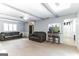 Open living room with beamed ceiling, stone fireplace, and view into the kitchen area at 1408 Fairfield Sw Dr, Lilburn, GA 30047
