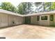 The back exterior of this single Gathering home features a concrete patio and lots of room for storage at 1408 Fairfield Sw Dr, Lilburn, GA 30047
