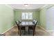 Cozy dining room with a table and six chairs in a naturally lit space at 1408 Fairfield Sw Dr, Lilburn, GA 30047