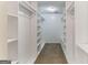 Walk-in closet with lots of shelving and rod space for organized storage at 1408 Fairfield Sw Dr, Lilburn, GA 30047