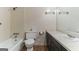Clean bathroom featuring a tub/shower combo, toilet, and single sink vanity at 1408 Fairfield Sw Dr, Lilburn, GA 30047
