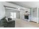 Spacious living room features a stone fireplace, beamed ceilings, and sliding glass doors at 1408 Fairfield Sw Dr, Lilburn, GA 30047