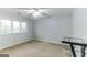 Comfortable bedroom featuring a ceiling fan, carpet flooring, and large windows at 1408 Fairfield Sw Dr, Lilburn, GA 30047