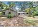 The back exterior of this single Gathering home features a large stone patio perfect for entertaining at 1408 Fairfield Sw Dr, Lilburn, GA 30047