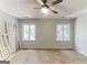 Bedroom featuring neutral walls, two windows, and a ceiling fan at 1408 Fairfield Sw Dr, Lilburn, GA 30047