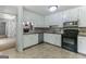 Well-lit kitchen boasts stainless steel appliances and ample cabinet space at 1408 Fairfield Sw Dr, Lilburn, GA 30047