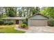 Ranch-style home with a stone accent and gray siding; garage and landscaped yard at 1408 Fairfield Sw Dr, Lilburn, GA 30047