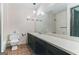 Bathroom with a large mirror, long vanity, and hexagon tile floors at 1408 Fairfield Sw Dr, Lilburn, GA 30047