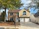 Charming brick home with two-car garage, manicured lawn, and inviting front entrance at 4369 Estate St, South Fulton, GA 30349