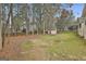 Large backyard with mature trees and utility shed at 618 Grecken Green, Peachtree City, GA 30269