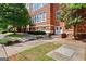 Brick building with charming landscaping, walkway, and manicured green space at 978 N Avenue Ne 307, Atlanta, GA 30306