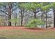 A picturesque backyard with lush grass, mature trees, and a gentle slope, perfect for outdoor enjoyment at 4607 Ravenwood Loop, Union City, GA 30291