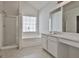 Bright bathroom featuring a shower, tub, window with blinds and an extended vanity area with sink and mirror at 4607 Ravenwood Loop, Union City, GA 30291